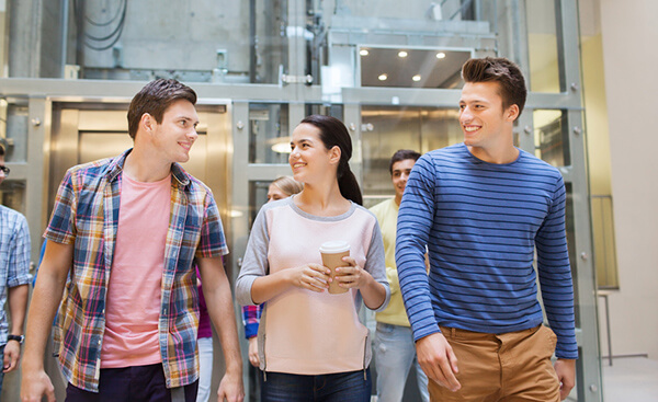 education, high school, friendship, drinks and people concept - group of smiling students with paper coffee cups